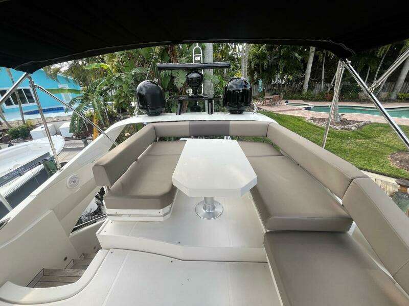 2017 Marquis 500 Sport Yacht with outdoor seating and table.