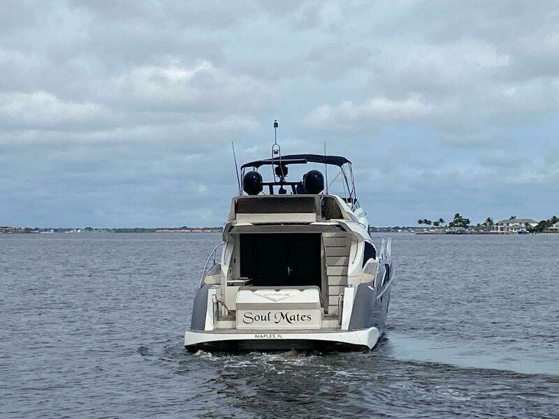 2017 Marquis 500 Sport Yacht Soul Mates cruising on a calm waterway.