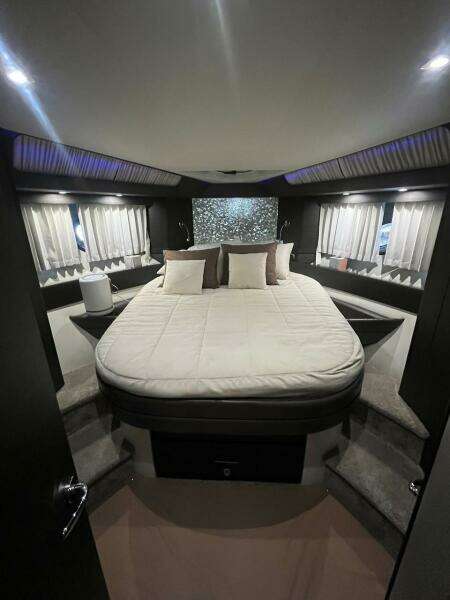 Luxurious bedroom interior of 2017 Marquis 500 Sport Yacht with modern design.