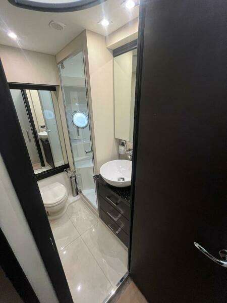 Modern bathroom in 2017 Marquis 500 Sport Yacht with sleek fixtures and ample lighting.