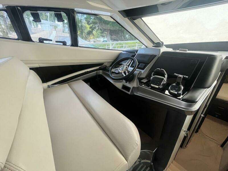 Interior helm of 2017 Marquis 500 Sport Yacht with modern controls and steering wheel.