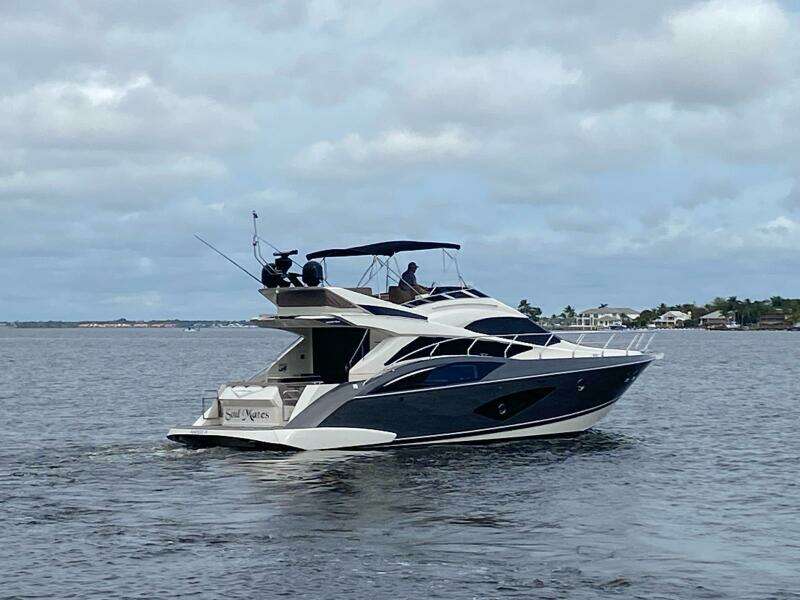 2017 Marquis 500 Sport Yacht cruising on a calm waterway.