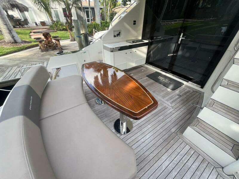 2017 Marquis 500 Sport Yacht deck with seating and wooden table.