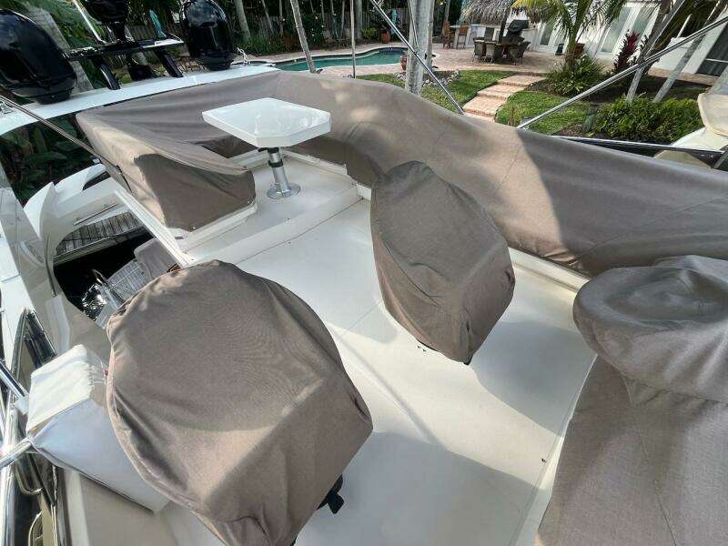 2017 Marquis 500 Sport Yacht deck with covered seating and table.