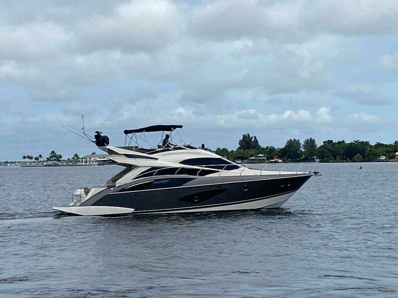 2017 Marquis 500 Sport Yacht cruising on a calm lake.