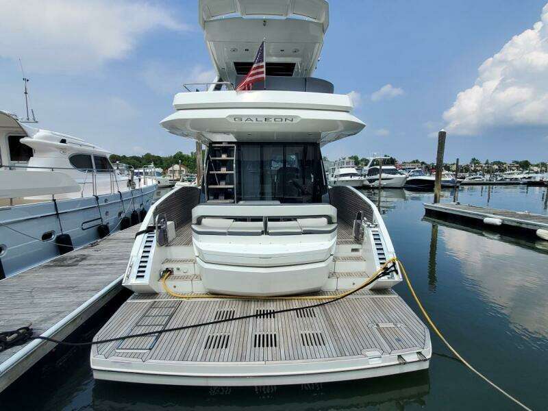 2020 Galeon 500 Fly yacht docked at marina, rear view.