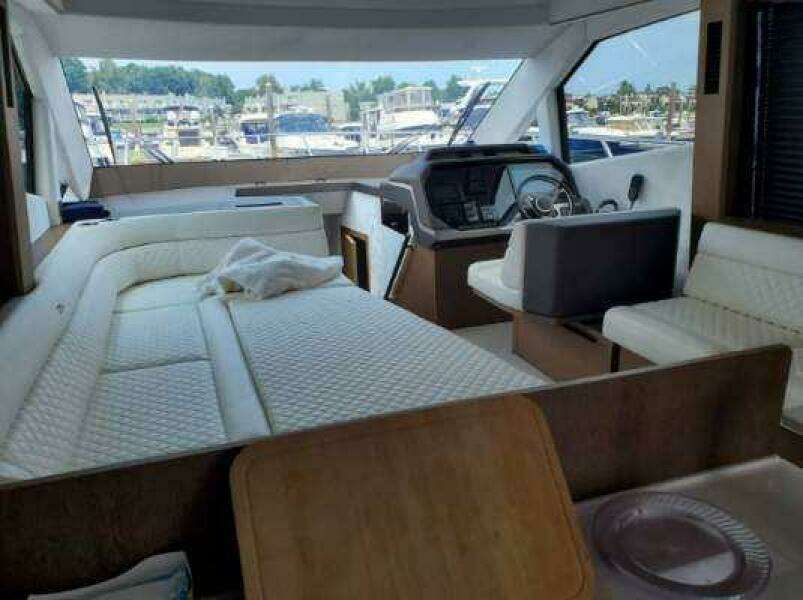 Interior of 2020 Galeon 500 Fly yacht with white seating and helm station.