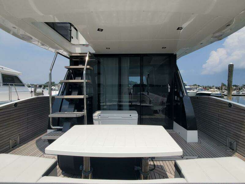 Galeon 500 Fly 2020 yacht with outdoor seating and staircase to upper deck.