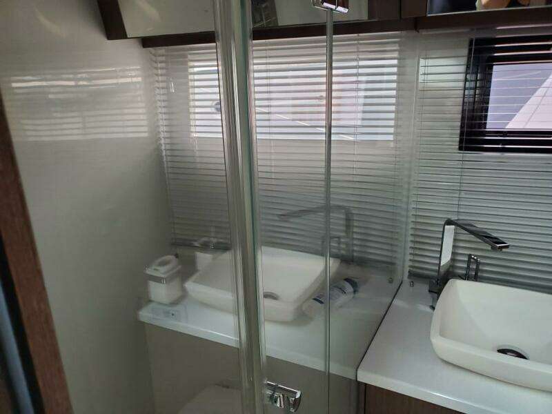 Modern bathroom in 2020 Galeon 500 Fly yacht with dual sinks and glass shower.