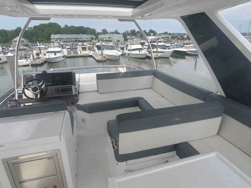 Flybridge of 2020 Galeon 500 Fly yacht with marina view.