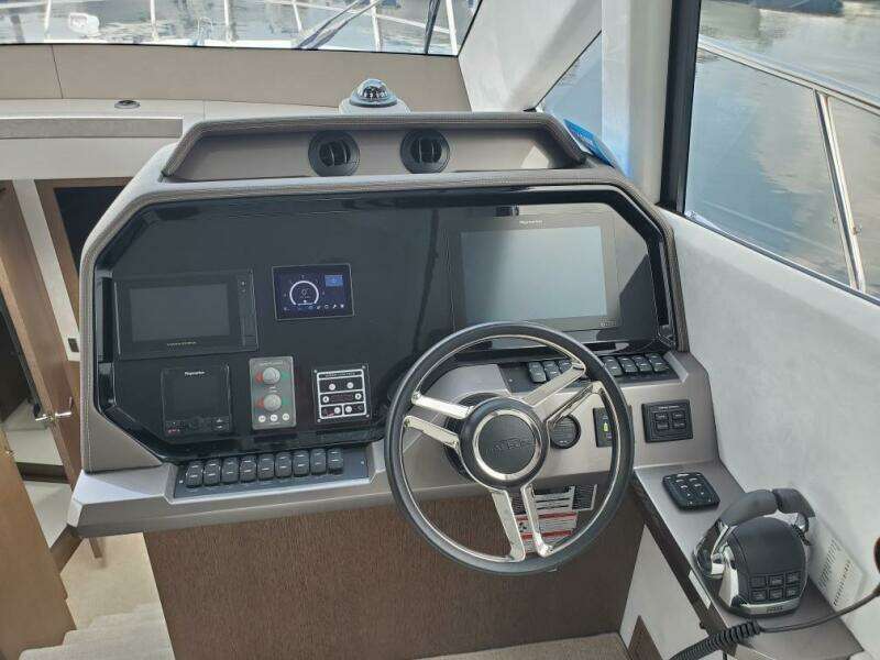 Helm station of 2020 Galeon 500 Fly yacht with modern navigation equipment.