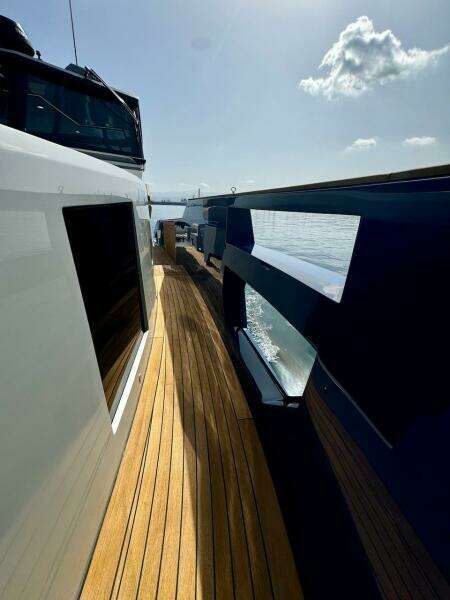 2025 Aicon Audace 50 yacht with sleek design and wooden deck, cruising on a sunny day.