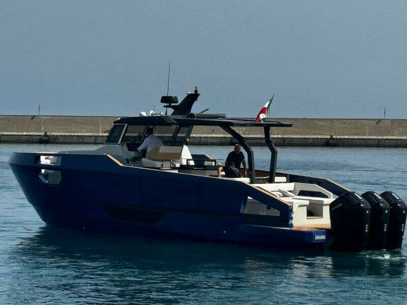 Aicon Audace 50 yacht, 2025 model, cruising in calm waters near a breakwater.