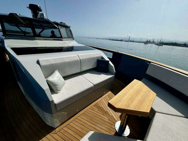 Luxurious 2025 Aicon Audace 50 yacht deck with modern seating and wooden table.