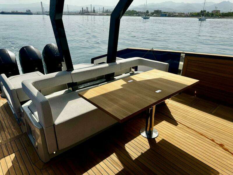 Aicon Audace 50 yacht deck with seating and table, 2025 model, on calm water.