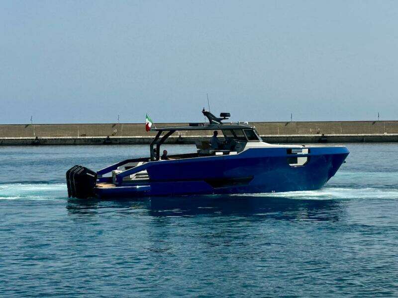Aicon Audace 50 yacht, 2025 model, cruising in a harbor with a clear blue sky.