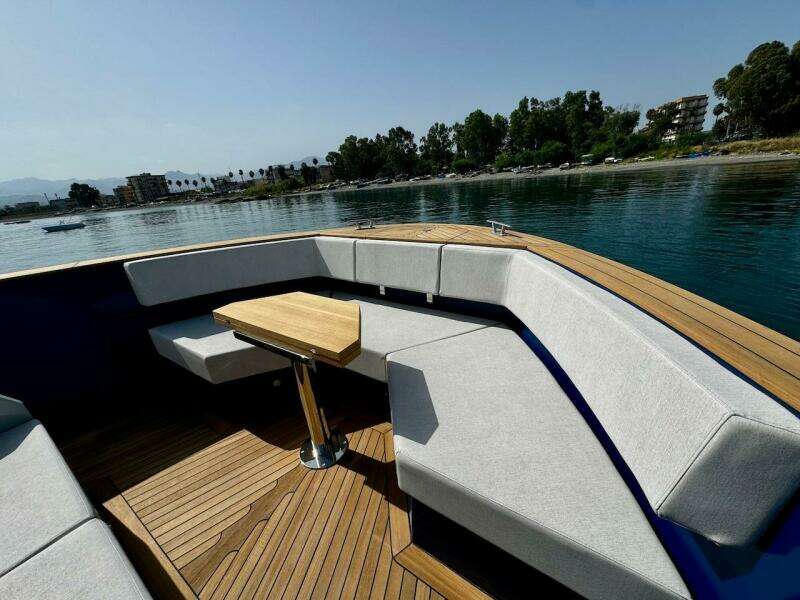 Luxurious Aicon Audace 50 yacht interior, 2025 model, with elegant seating and wooden table.