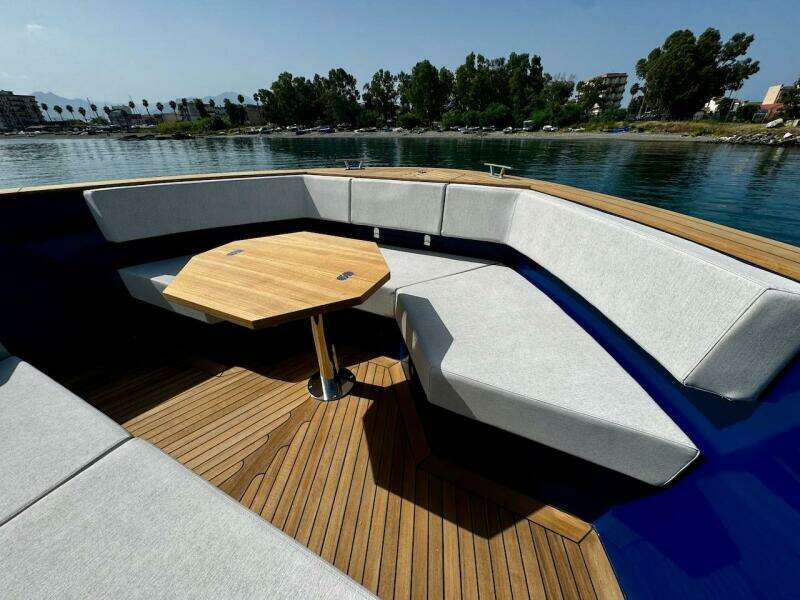 Luxurious 2025 Aicon Audace 50 yacht with elegant seating and wooden deck.