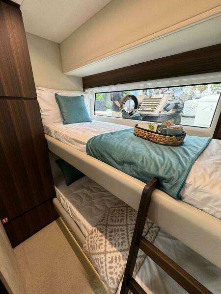 2024 Aicon 66 Vivere yacht cabin with bunk beds and window view.