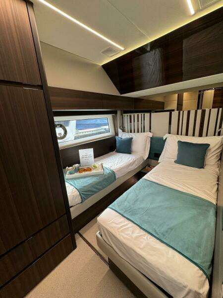Luxurious 2024 Aicon 66 Vivere yacht cabin with twin beds and elegant decor.