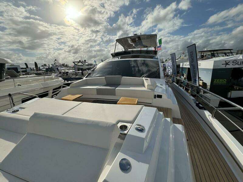 2024 Aicon 66 Vivere luxury yacht at marina under cloudy sky.