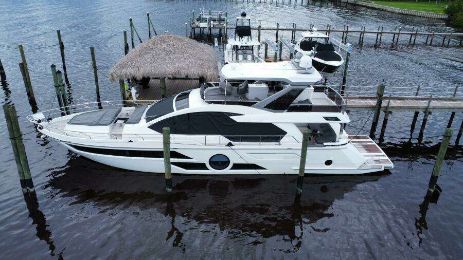 2024 Aicon 66 Vivere yacht docked at marina, aerial view.