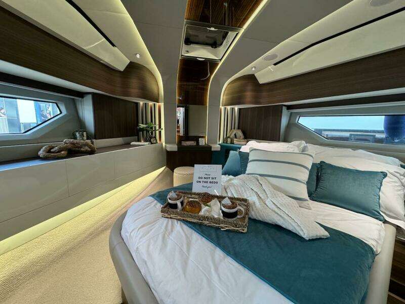 Luxurious 2024 Aicon 66 Vivere yacht bedroom with elegant decor and breakfast tray.