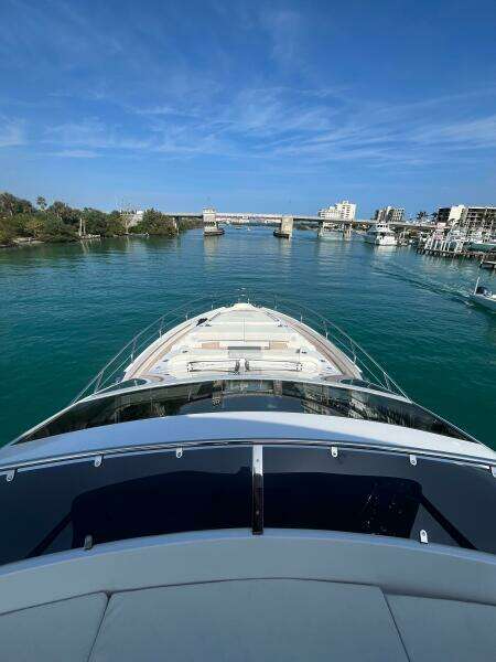 2024 Aicon 66 Vivere yacht cruising in a scenic coastal waterway.
