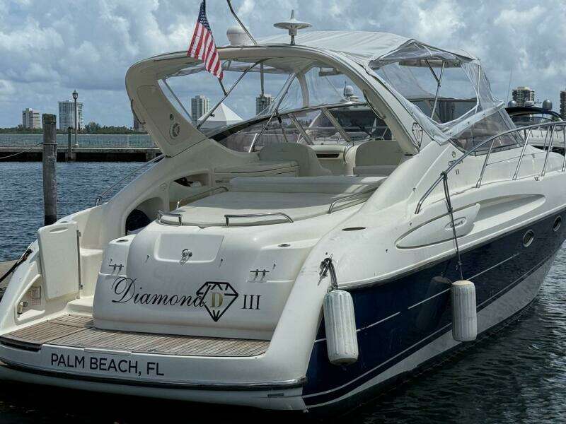 2003 Cranchi Endurance 39 yacht docked in Palm Beach, FL, with American flag.