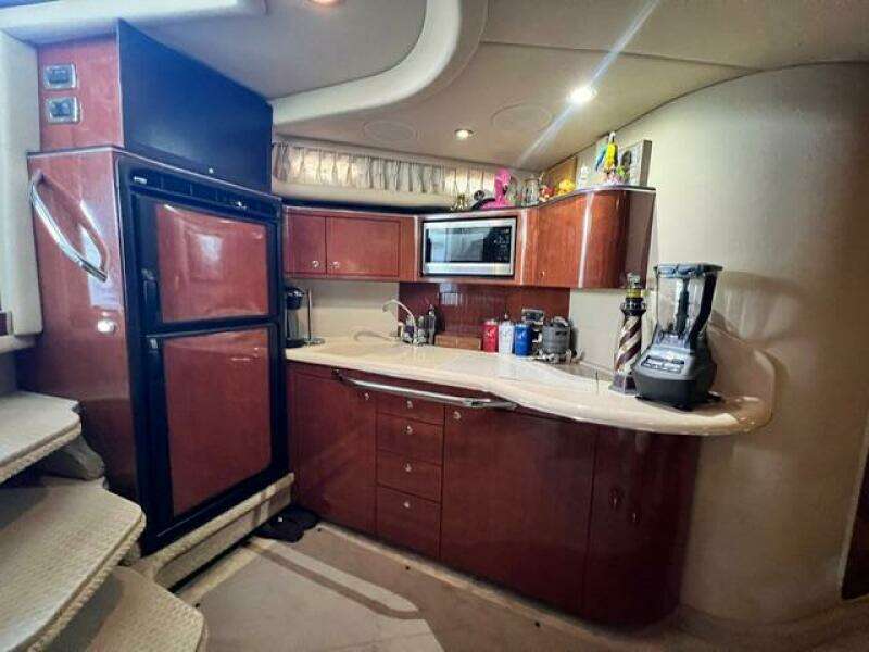Luxurious kitchen interior of 2003 Sea Ray 380 Sundancer yacht with modern appliances.