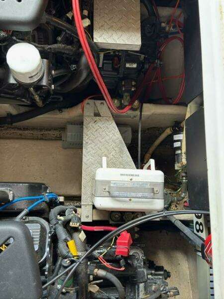 Engine compartment of a 2003 Sea Ray 380 Sundancer with visible wiring and components.