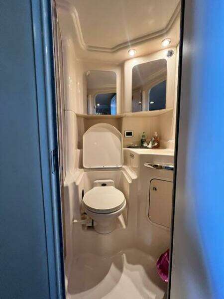 Bathroom interior of 2003 Sea Ray 380 Sundancer yacht, featuring toilet and vanity.