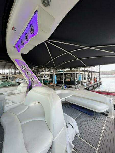 2003 Sea Ray 380 Sundancer boat interior with white seating and purple LED lights.