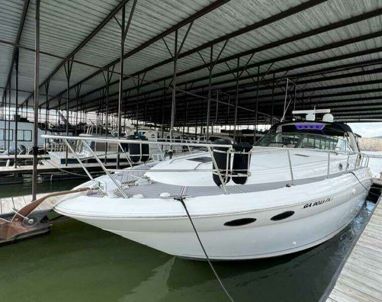2003 Sea Ray 380 Sundancer docked in a covered marina.