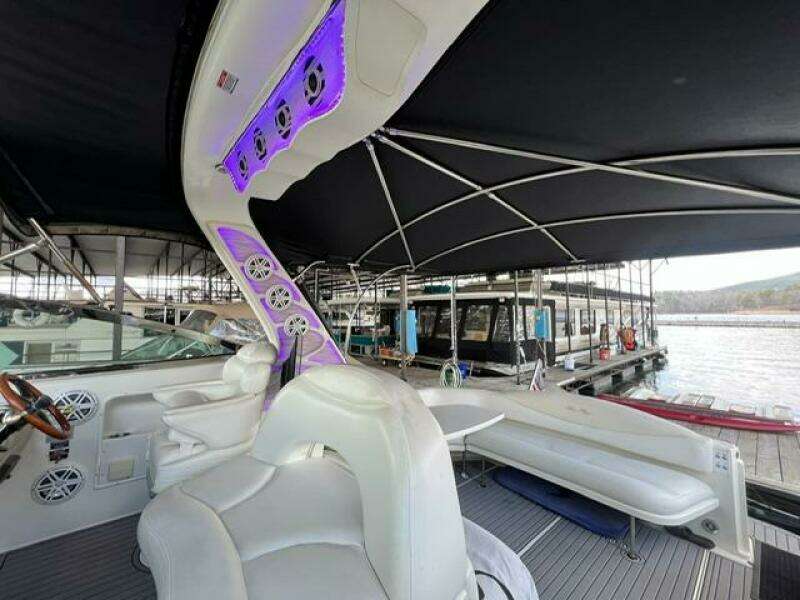 2003 Sea Ray 380 Sundancer yacht interior with seating and canopy at marina.