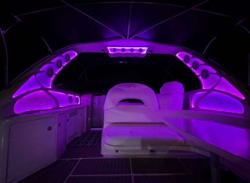 Interior of 2003 Sea Ray 380 Sundancer with vibrant purple LED lighting.