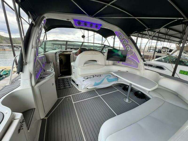 2003 Sea Ray 380 Sundancer interior with seating, table, and ambient lighting.