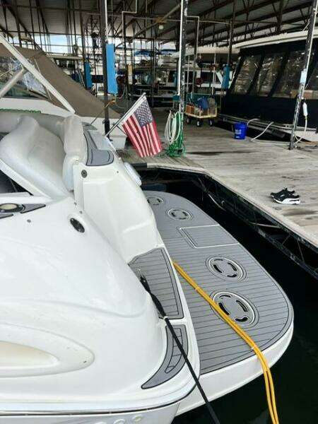 2003 Sea Ray 380 Sundancer docked, featuring swim platform and American flag.
