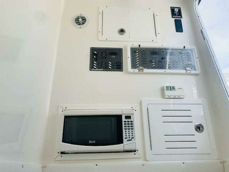 Control panel and microwave on 2020 SeaHunter 39 Tournament boat interior.