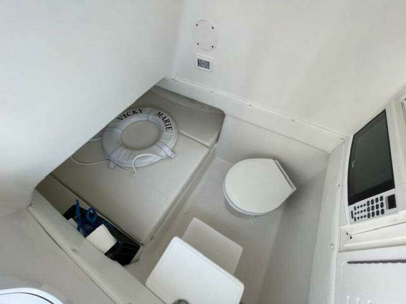 Interior of 2020 SeaHunter 39 Tournament boat with seating, toilet, and life preserver.