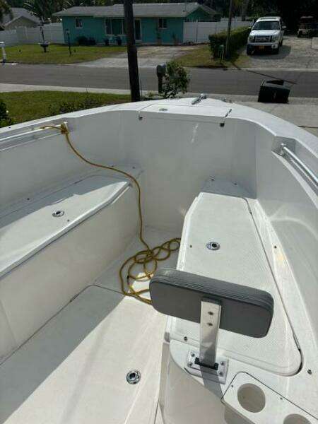 2016 Release 208 RX boat interior with seating and rope, parked in a residential area.