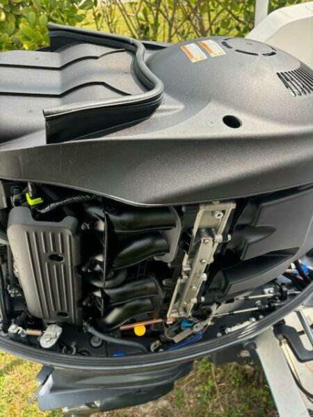 Close-up of a 2016 Release 208 RX boat engine, showcasing intricate mechanical components.