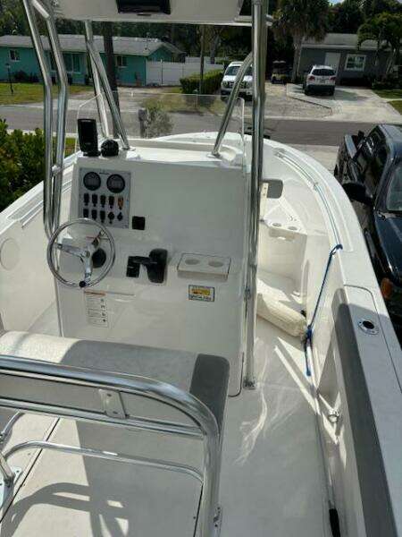2016 Release 208 RX boat with console and seating, parked in a residential area.
