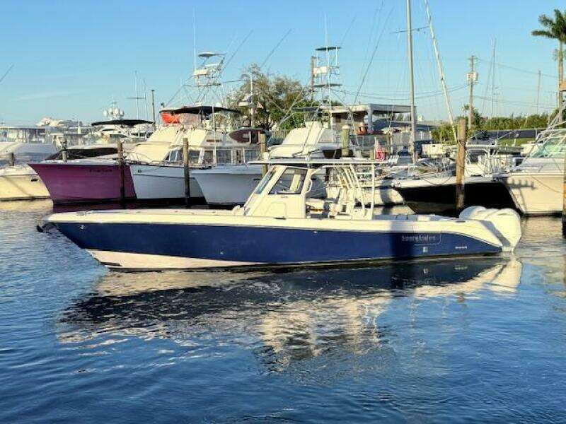 2014 Everglades 355 Center Console boat docked in a marina.