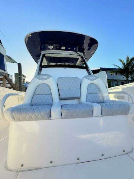 2014 Everglades 355 Center Console boat with cushioned seating and sleek design.