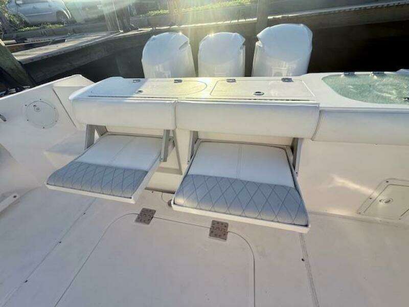 2014 Everglades 355 Center Console boat with foldable seats and triple engines.