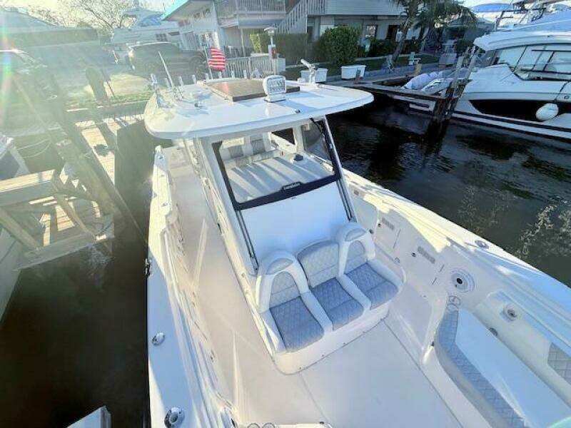2014 Everglades 355 Center Console boat docked at marina, featuring spacious seating.