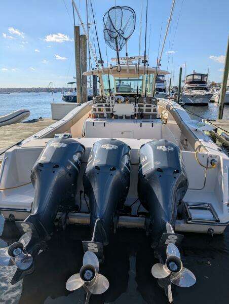 2012 Grady-White Canyon 366 boat with triple Yamaha outboard engines docked at marina.