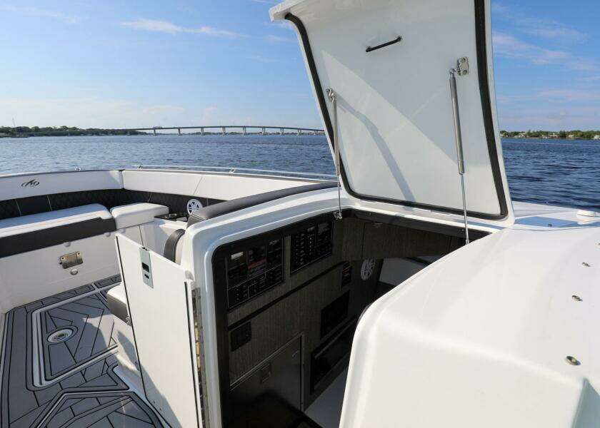 2023 Monterey 385 Super Sport boat interior with open hatch, on calm water.