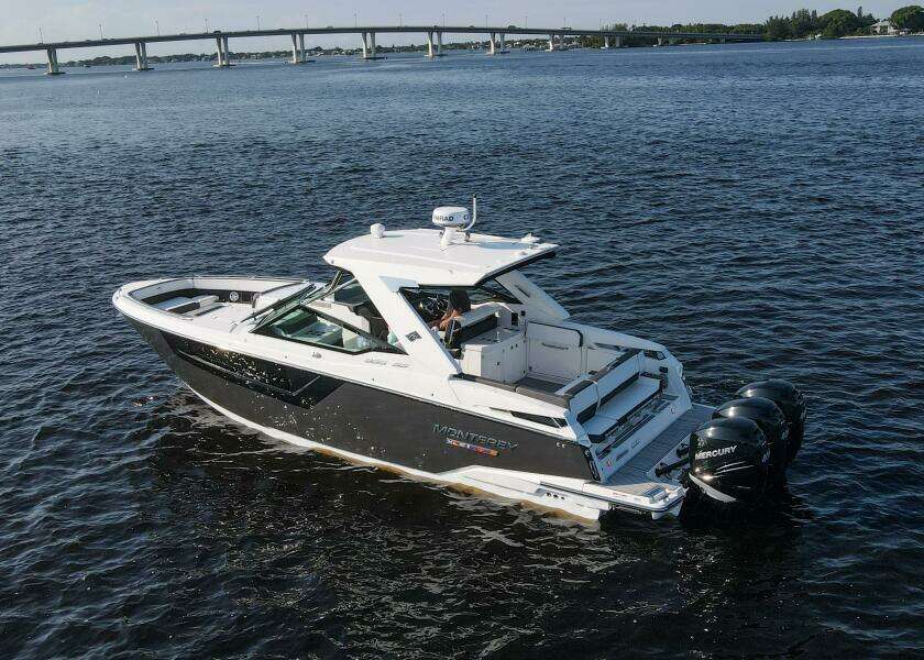 2023 Monterey 385 Super Sport boat on water with bridge in background.